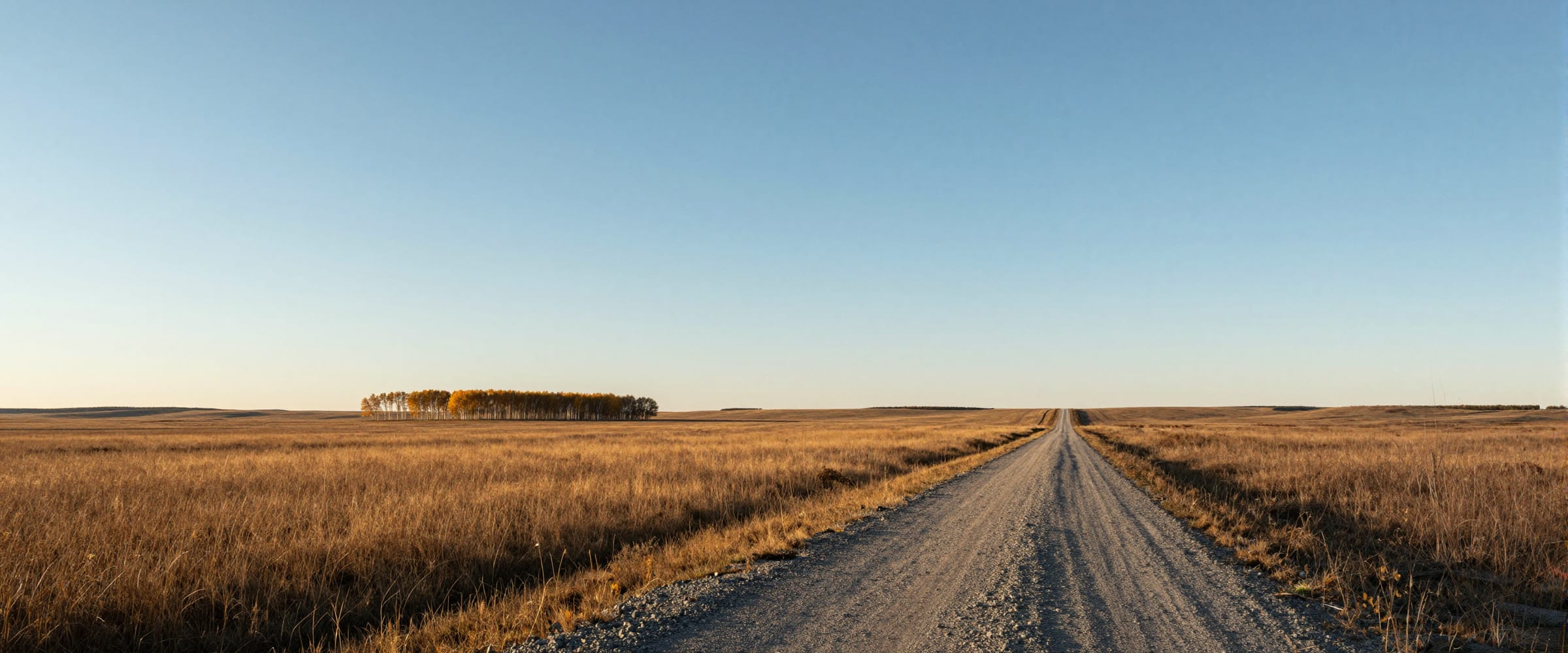 Open prairie under a wide sky, late in the day.